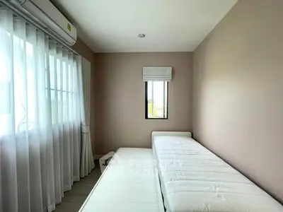 Cozy minimalist bedroom with natural light and air conditioning