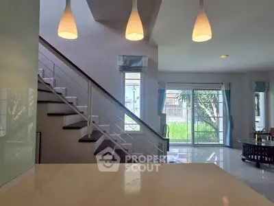 Modern living room with stylish staircase and large windows