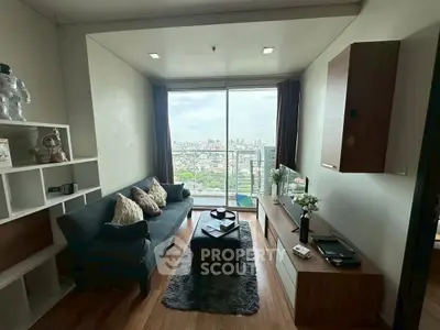 Modern living room with stunning city view, cozy sofa, and elegant decor.