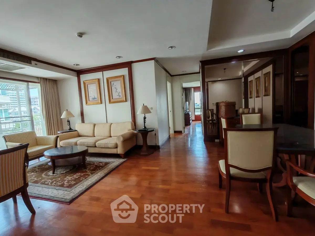 Spacious living room with elegant furniture and wooden flooring, perfect for relaxation and entertaining.