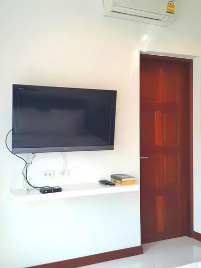 Modern living room with wall-mounted TV and air conditioning unit