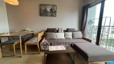 Modern living room with stylish furniture and large window offering city views