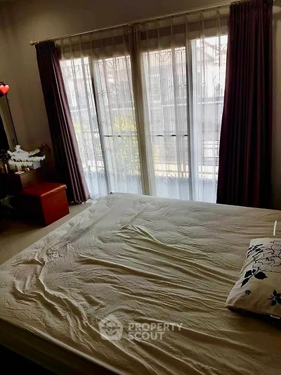 Cozy bedroom with large window and natural light