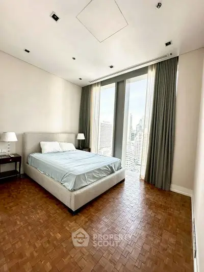Spacious bedroom with city view in modern high-rise apartment