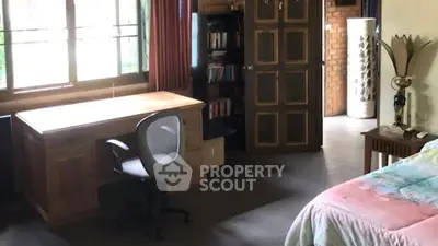 Spacious bedroom with study area and natural light in cozy home