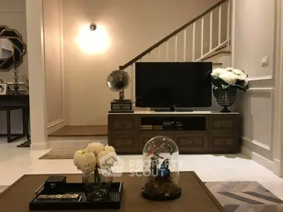 Elegant living room with vintage decor and modern TV setup