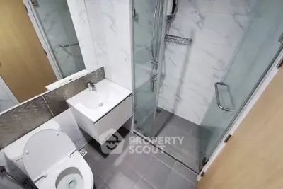 Modern bathroom with sleek shower and elegant fixtures in a contemporary apartment.