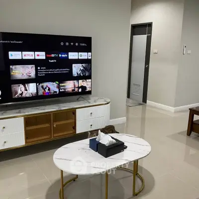 Modern living room with sleek TV setup and stylish coffee table