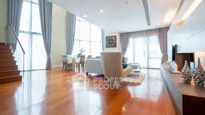 Luxurious open-plan living room with elegant decor and abundant natural light.