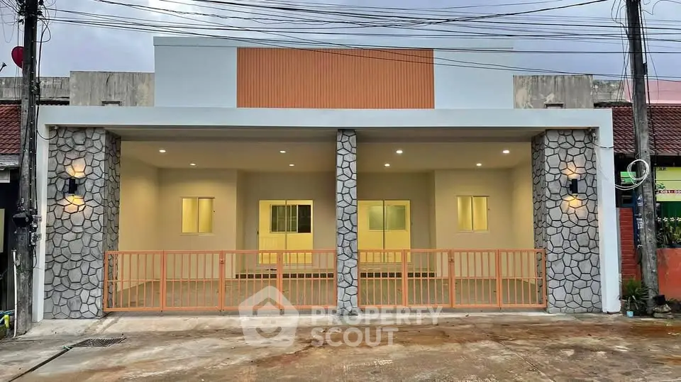 Modern single-story home with stone accents and spacious driveway