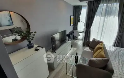 Modern living room with stylish decor and large windows for natural light.