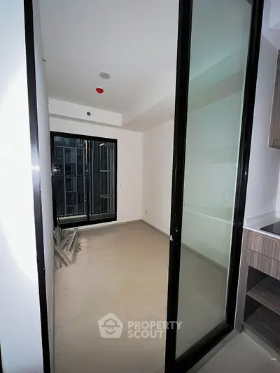 Modern apartment interior with sliding glass doors and sleek flooring