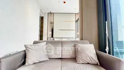 Modern living room with plush sofa and elegant decor in a high-rise apartment.