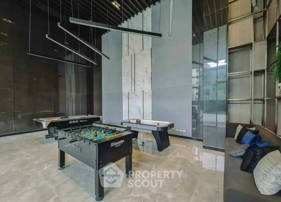 Luxurious game room with foosball and air hockey tables in modern building