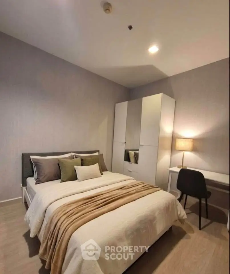 Cozy bedroom with modern decor, featuring a comfortable bed, stylish wardrobe, and a functional study desk.