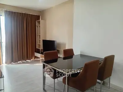 Modern dining area with sleek table and chairs, natural light through large window.