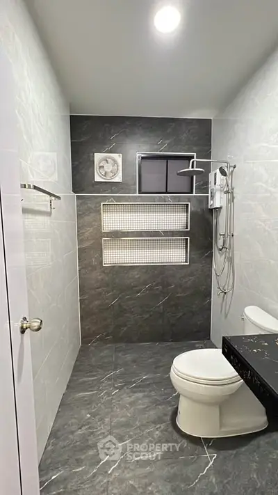 Modern bathroom with sleek gray tiles and contemporary fixtures