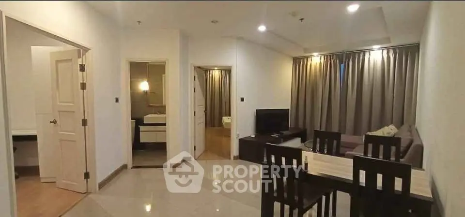 Spacious modern living room with dining area and open layout, perfect for comfortable living.