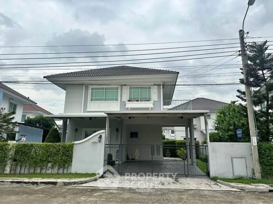 Elegant two-story house with modern design and spacious driveway in a serene neighborhood.