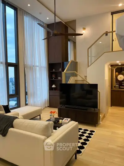 Luxurious modern living room with high ceilings and elegant decor in a stylish apartment.