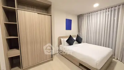 Modern bedroom with sleek wooden furniture and large window with curtains