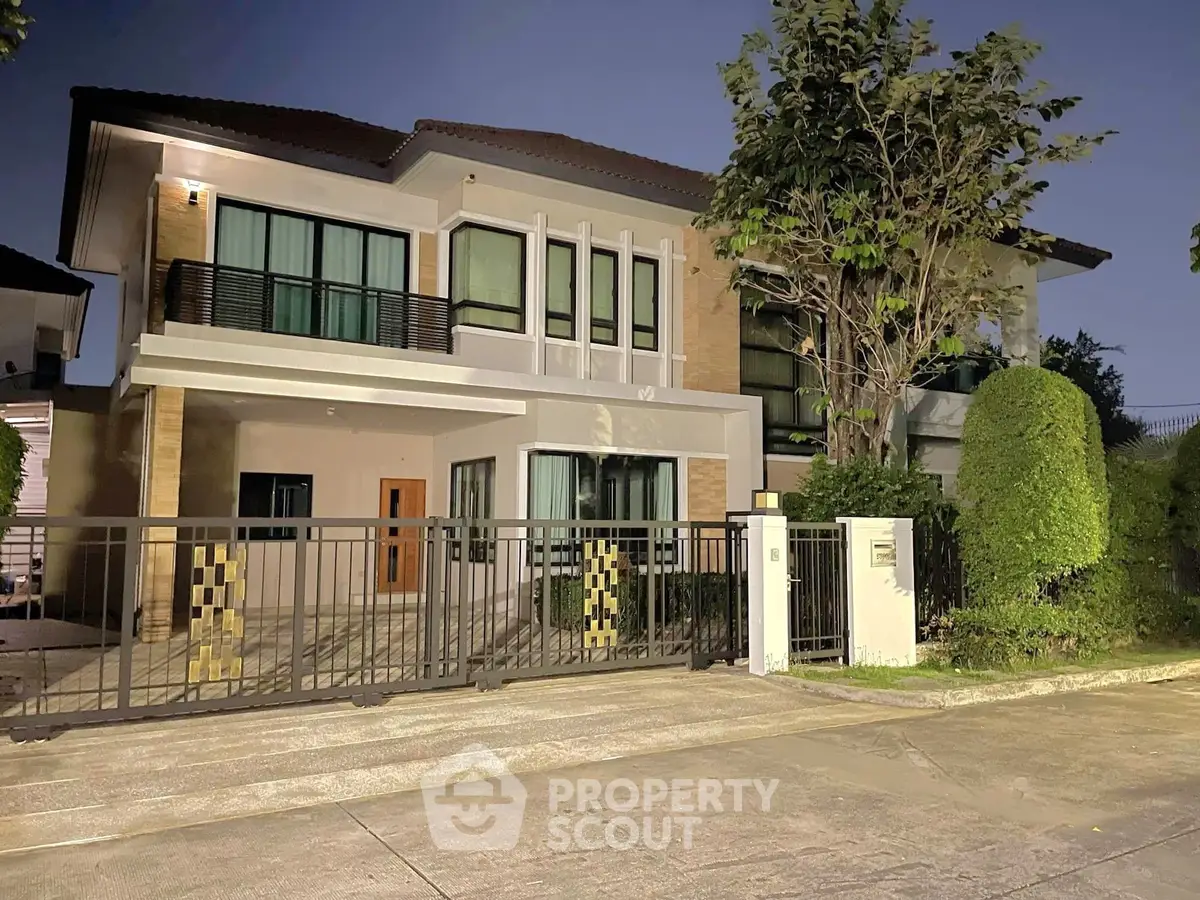 Elegant two-story house with modern design and lush greenery, perfect for family living.