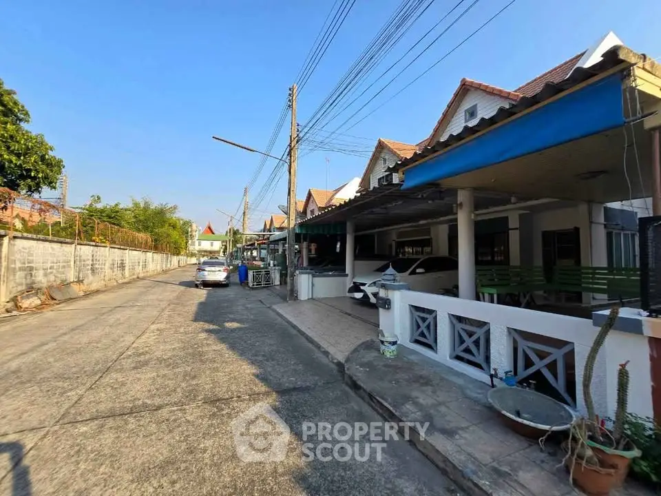 Charming residential street with cozy houses and clear blue sky, perfect for family living.