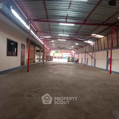 Spacious industrial warehouse with high ceiling and ample storage space.