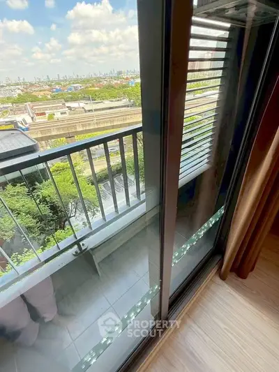 Stunning balcony view with cityscape and lush greenery, perfect for urban living.