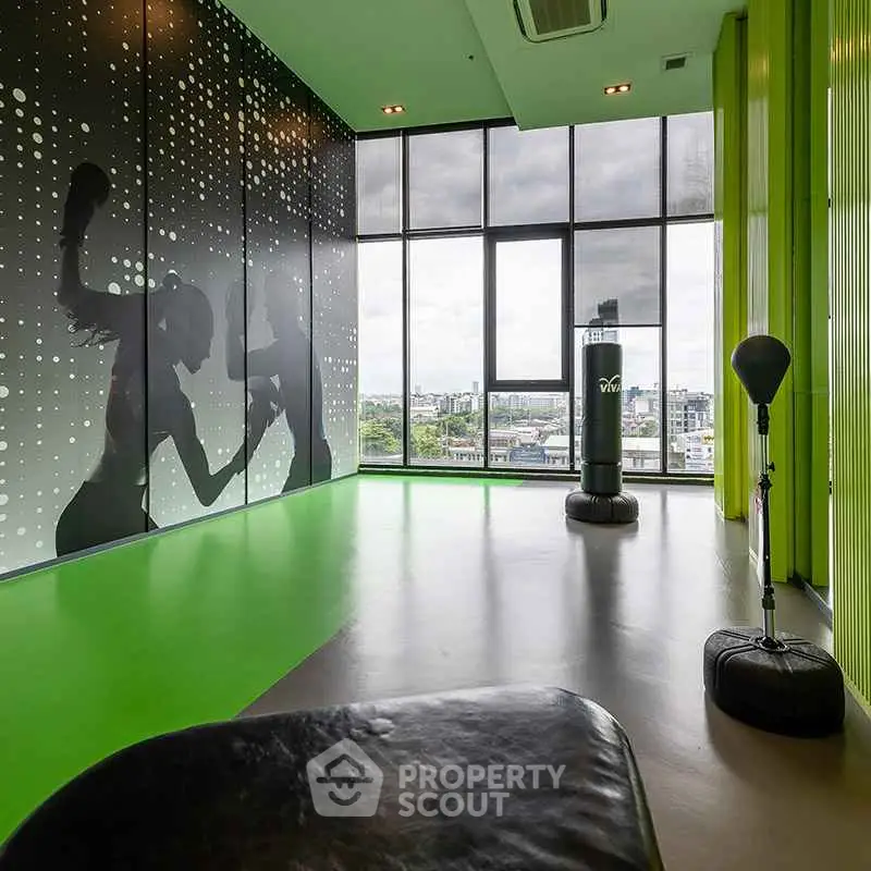 Modern gym with panoramic city view and vibrant green accents