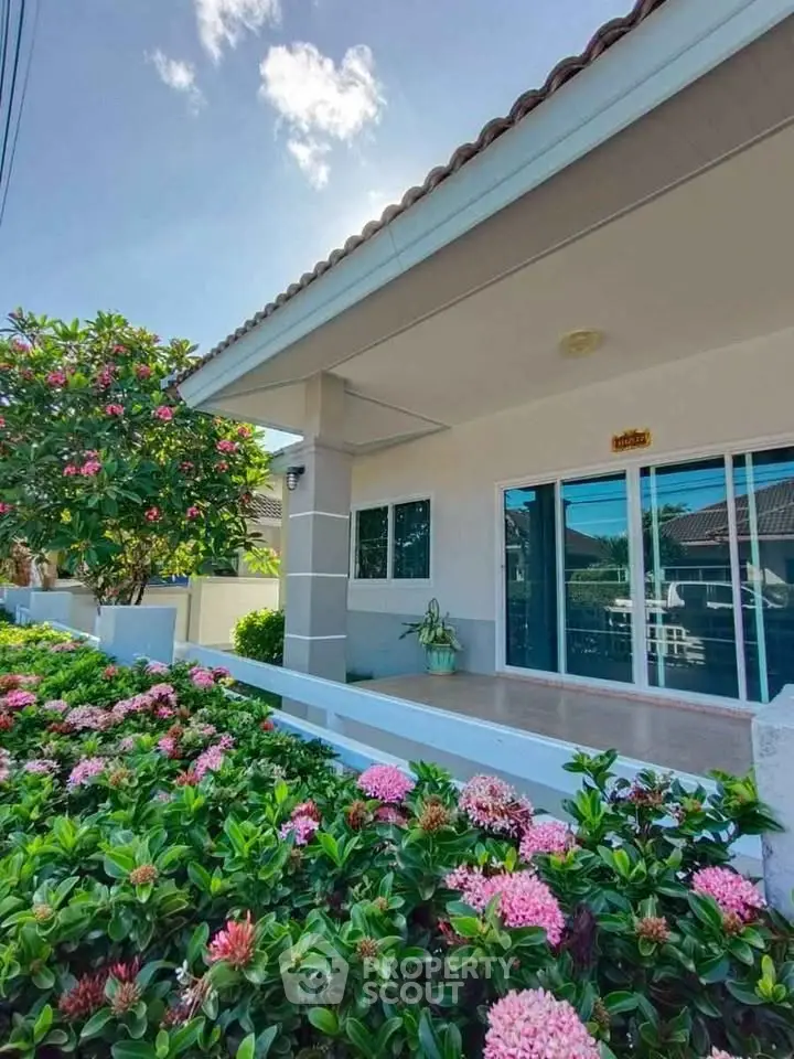 Charming single-story home with lush garden and spacious patio, perfect for relaxation.