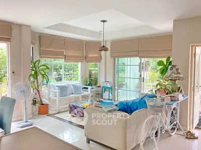 Bright and airy living room with large windows and cozy seating area