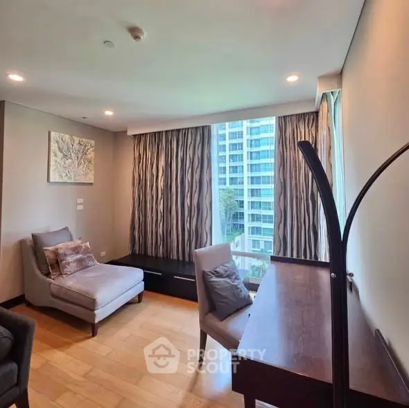 Modern study room with elegant decor and large window view in luxury apartment.