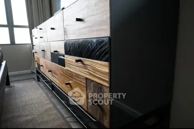 Stylish modern dresser with mixed wood textures in a contemporary bedroom setting.