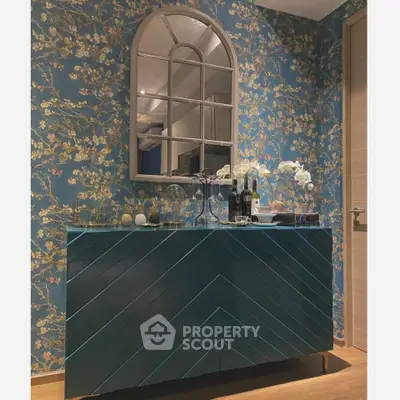 Stylish interior with elegant console table and floral wallpaper, perfect for modern living spaces.