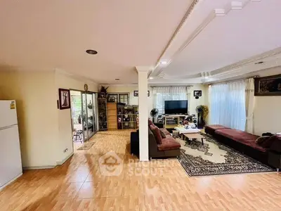 Spacious living room with elegant decor and ample natural light, perfect for family gatherings.