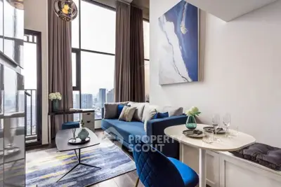 Stylish modern living room with blue sofa and city view, perfect for urban living.