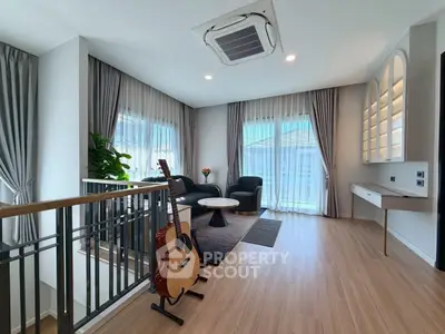 Modern living room with stylish decor and natural light, featuring a guitar and elegant furnishings.