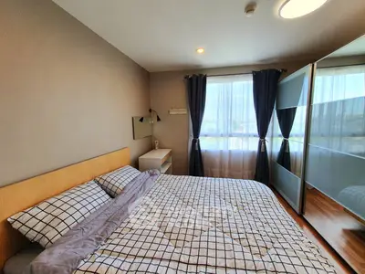Cozy bedroom with modern decor and large window for natural light