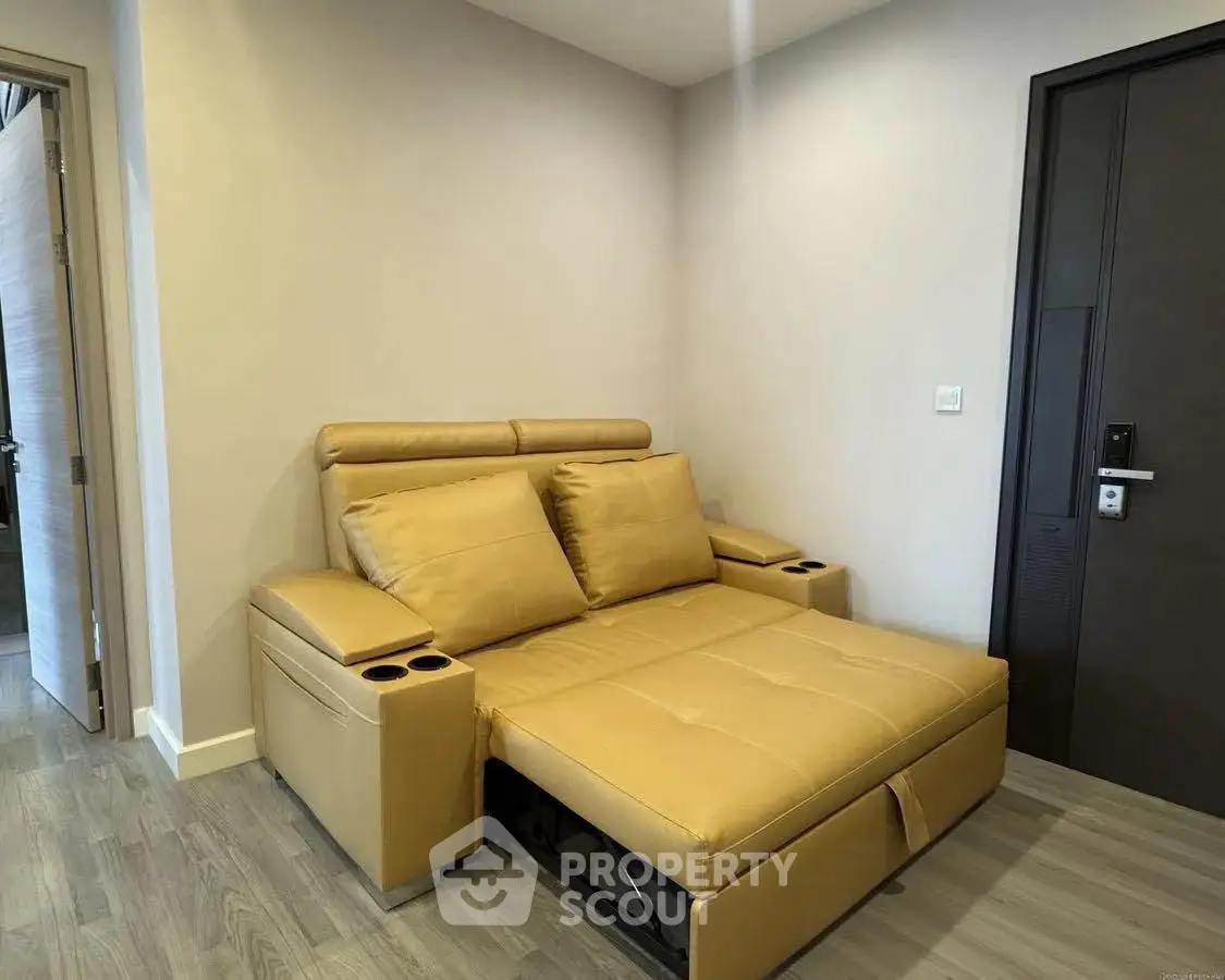 Modern living room with stylish beige sofa bed and sleek wooden flooring.