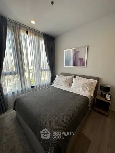 Modern bedroom with large window and stylish decor