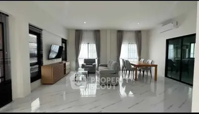 Spacious modern living room with elegant decor and ample natural light