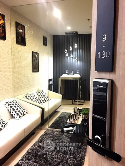 Modern living room with stylish decor and smart lock entry, featuring cozy seating and elegant lighting.