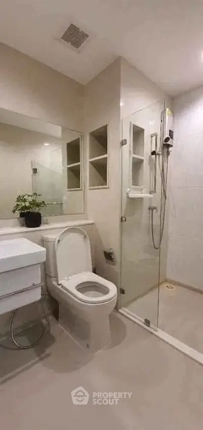 Modern bathroom with glass shower and sleek fixtures