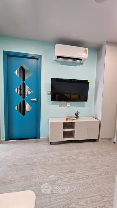 Modern living room with air conditioning and stylish blue door