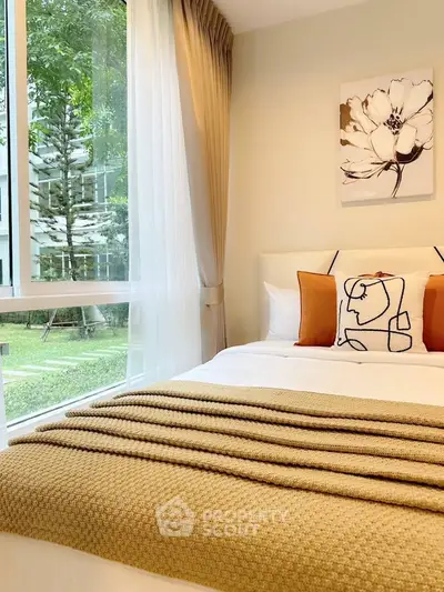Cozy bedroom with large window and garden view, featuring modern decor and warm tones.