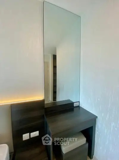 Modern bedroom with sleek vanity mirror and stylish lighting