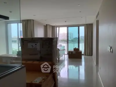 Spacious living room with large windows offering stunning cityscape views, perfect for modern urban living.