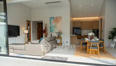 Modern open-plan living room and kitchen with stylish furniture and decor