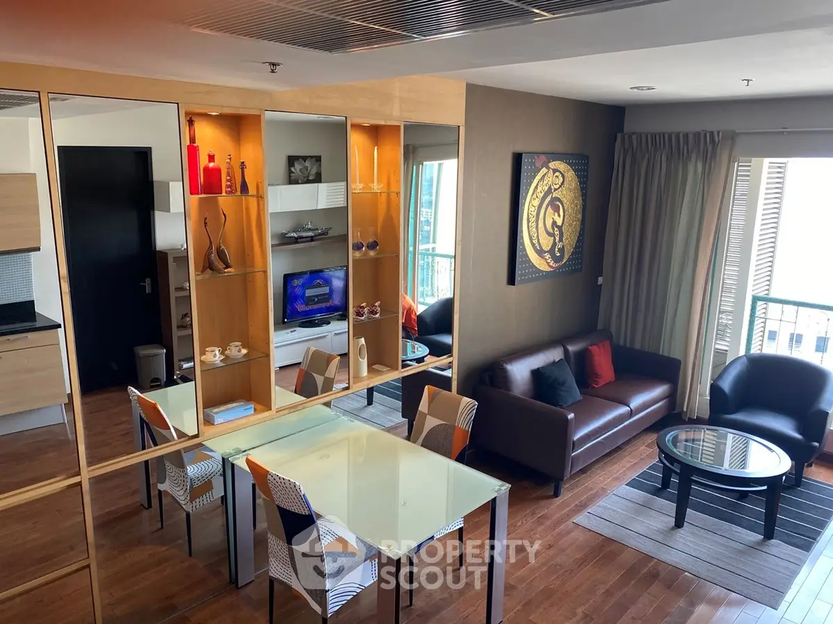 Modern living room with stylish decor, glass dining table, and cozy seating area in a high-rise apartment.